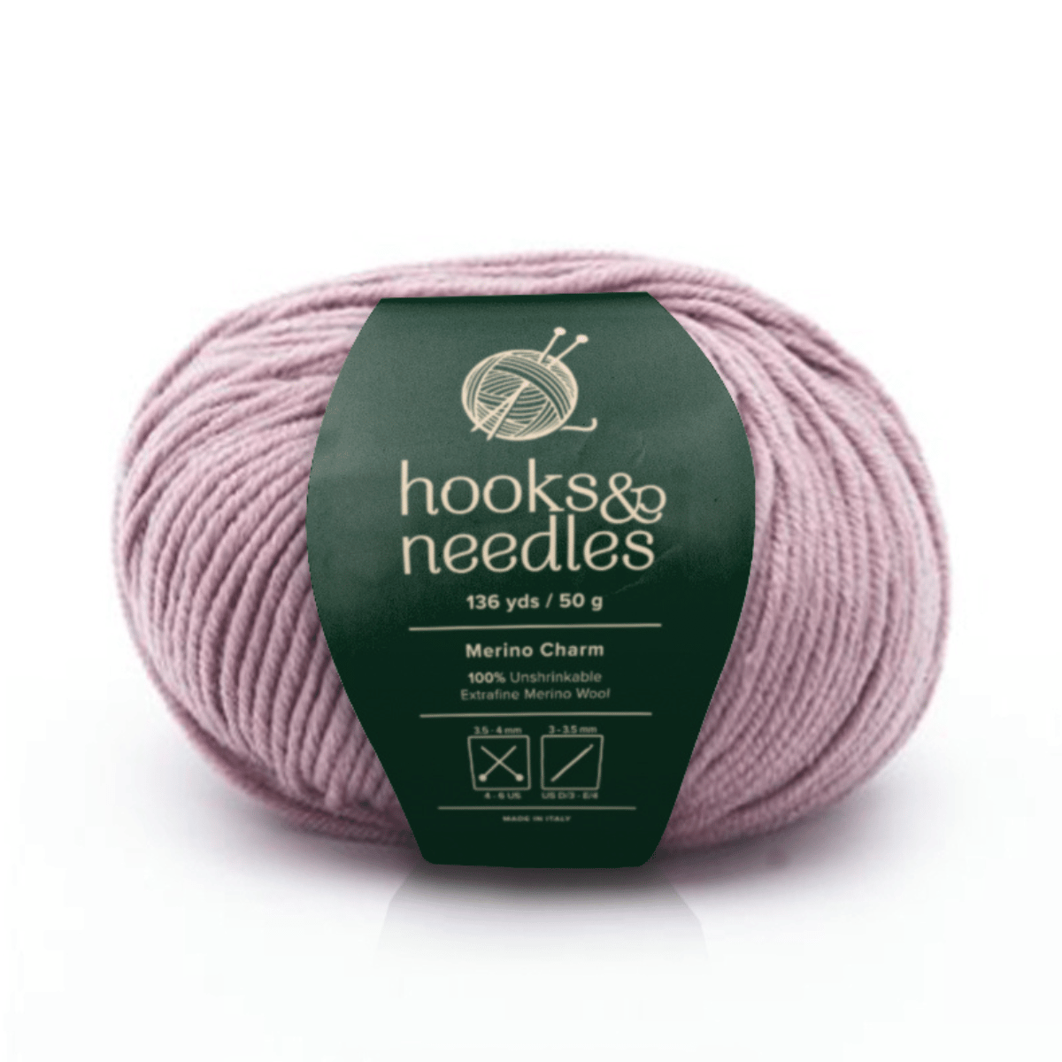 A ball of light mauve Merino Charm Yarn 50g with care instructions and logo on a green "hooks & needles" wrapper.