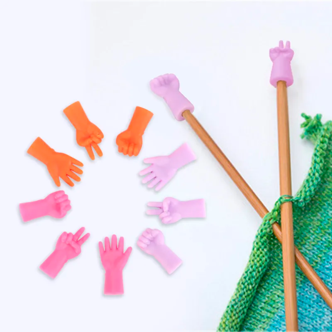 Colorful Knitting Needles Point Protectors 6pcs styled as hands paired with matching rubber finger gloves and vibrant colors, arranged around a knit fabric.