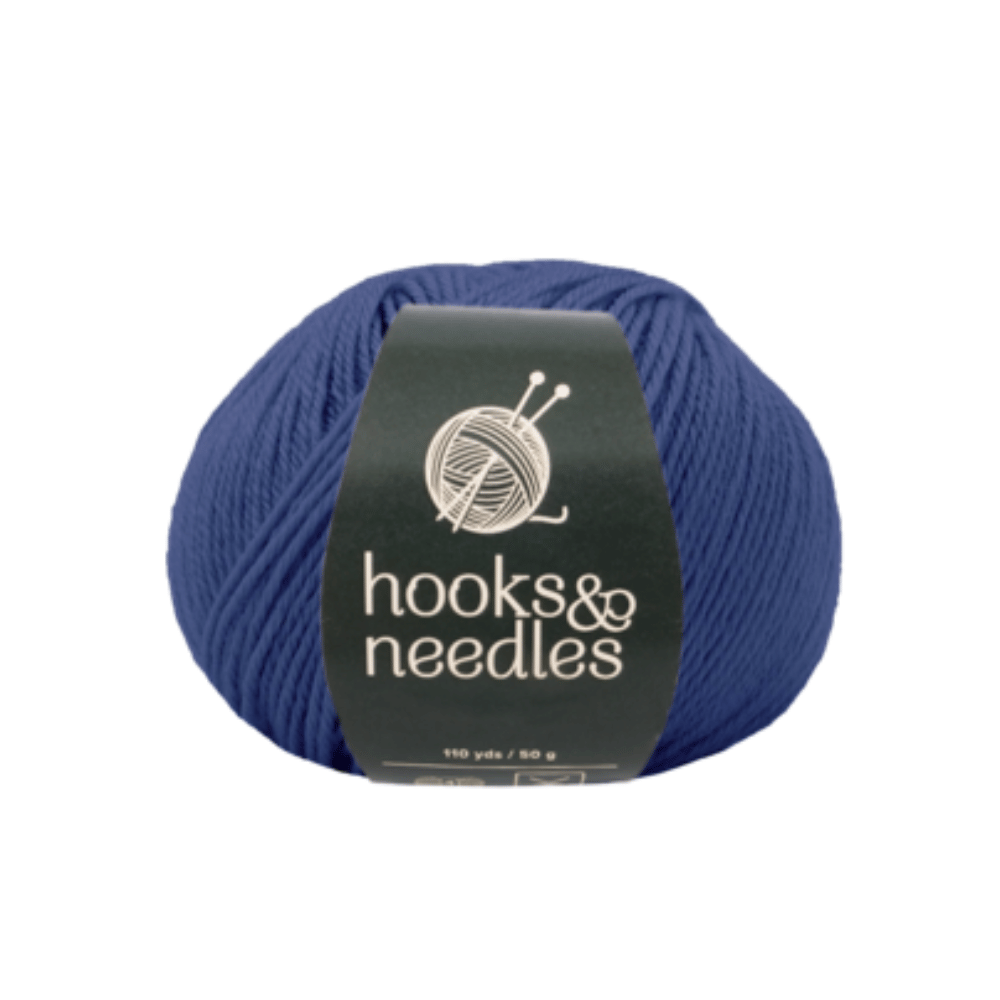 The Fuzzy Whirl Yarn 100g, a ball of dark blue acrylic yarn from the "hooks & needles" collection, featuring a knitting needles logo, is perfect for your next Aran weight project.