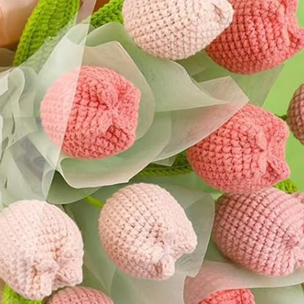The Crochet Tulip Bouquet Kit features pink and light pink crocheted tulips wrapped in translucent paper—a charming, everlasting gift for any occasion that delights with beauty that never fades.