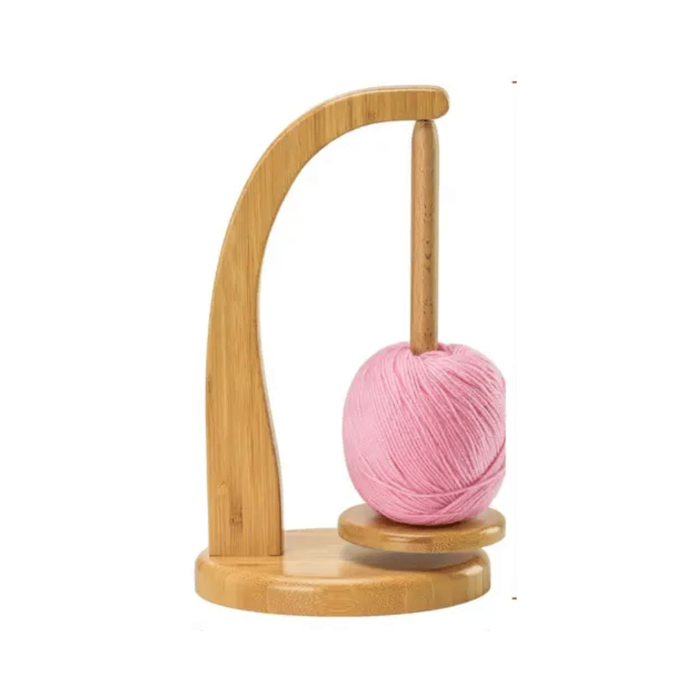 Levitating Premium Yarn Holder showcasing a pink yarn ball on a spindle against a white backdrop, designed with magnetic features for a seamless knitting experience.