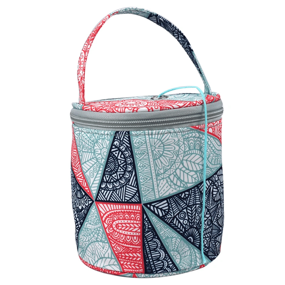 The Round Yarn Storage Bag features a zippered top and a blue, red, and white geometric pattern in an insulated design. It's equipped with a carrying handle and is not only portable but also versatile enough to serve as both a lunch bag and storage for your knitting supplies.