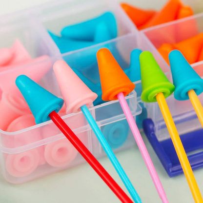 The Knitting Needles Point Protectors 25pcs are neatly organized by color in a compartmentalized storage box, resembling colorful silicone earplugs on long sticks.