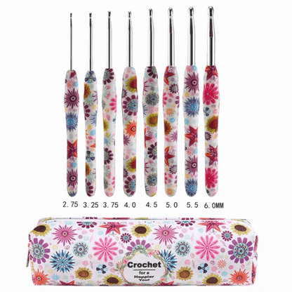 The 29-Piece Crocheting Kit: Perfect for Beginners includes a set of eight crochet hooks with colorful patterned handles, ranging in sizes from 2.75mm to 6.0mm, displayed above a matching zippered carrying case labeled "Crochet for a Happier." 