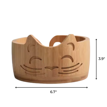 The Cat Yarn Bowl features a charming cat face design and measures 6.7" wide by 3.9" tall, making it perfect for kitty-loving crafters.