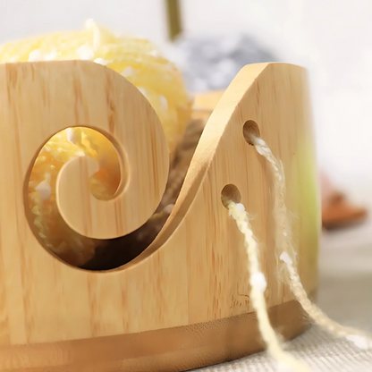 A close-up of the Cat Yarn Bowl, featuring a swirl cutout and side holes for threading yarn. This cute bowl with a kitty design adds a playful touch to any knitting setup while keeping your yarn organized.