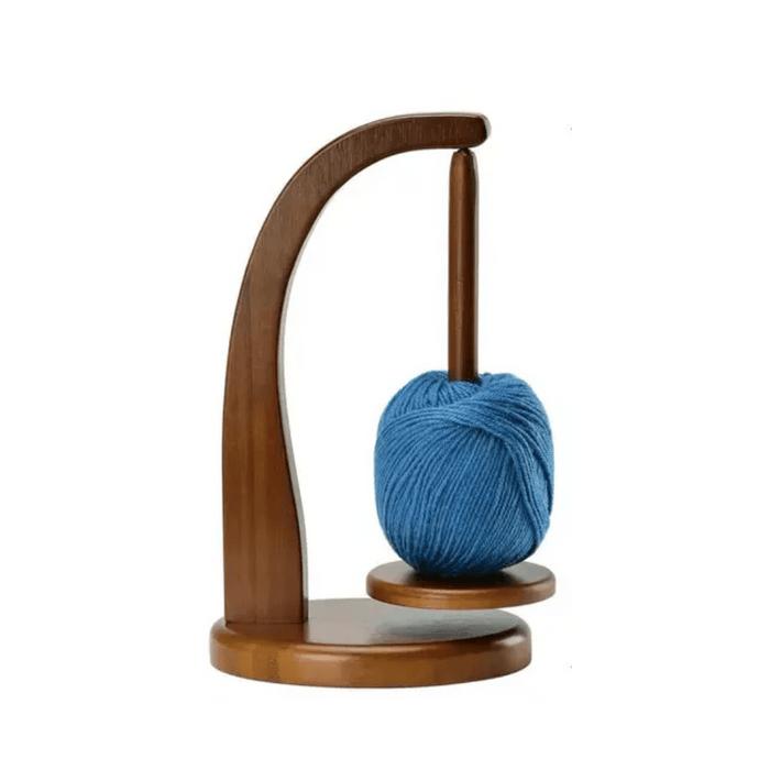 Levitating Premium Yarn Holder with a ball of blue yarn gracefully suspended on a vertical spindle, providing an effortless knitting experience.