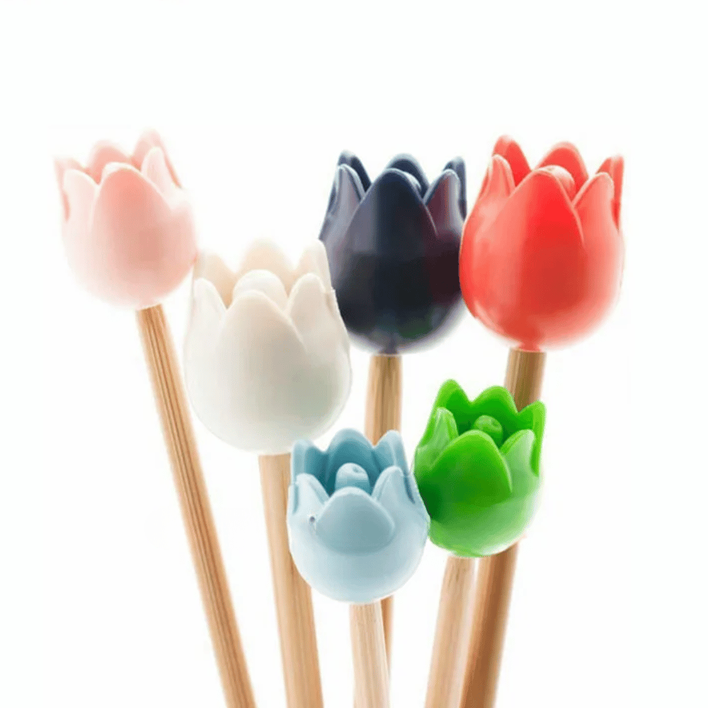 A set of six tulip-shaped ceramic chopstick rests in a variety of colors—pink, black, red, white, blue, and green—brings a stylish touch to your dining setup. Accompanied by the Tulip Rubber Point Protectors Small for needle shielding, these wooden chopsticks combine durability with elegance.