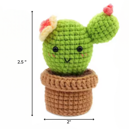 The Crochet Cactus Kit 3pcs features adorable crocheted cacti with pink flowers, black eyes, and smiles in brown pots. Each plush measures 2.5" tall and 2" wide—perfect for cute crochet home decor.