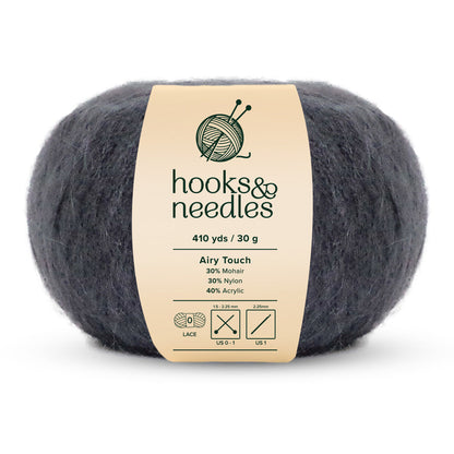 A ball of Airy Touch Yarn 30g, crafted from 30% mohair, 30% nylon, and 40% acrylic, offers 410 yards in a soft dark gray tone. It's perfect for creating delicate accessories or ethereal garments.