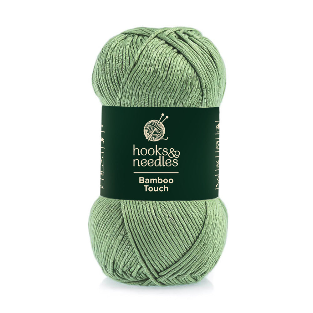 A skein of Bamboo Touch eco-friendly bamboo-blend green yarn with the brand label "hooks & needles".