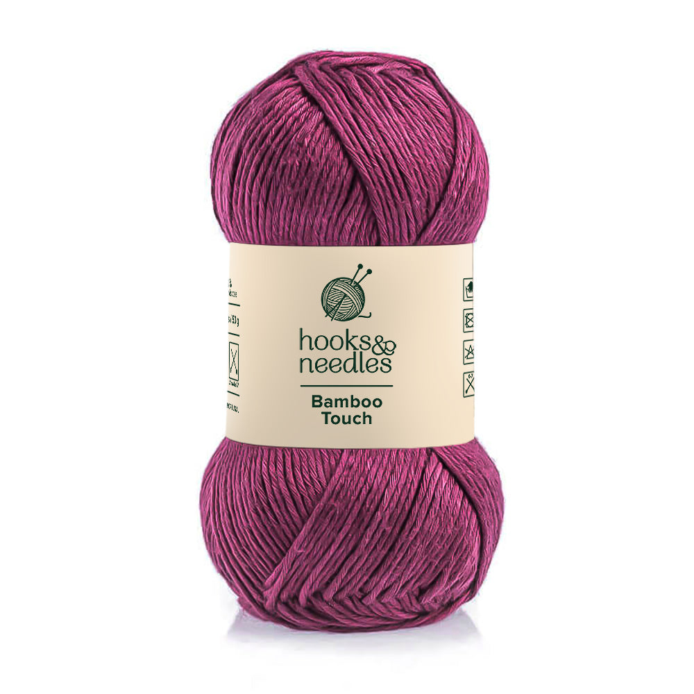 A skein of Bamboo Touch yarn in a deep pink hue.