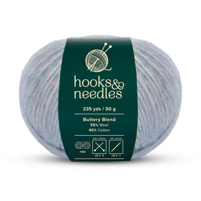 Introducing the Buttery Blend Yarn 50g by Hooks & Needles, this fine-weight yarn offers 235 yards per 50-gram ball. Composed of a soothing light blue blend of 55% wool and 45% cotton, it's an excellent choice for your crafting needs.