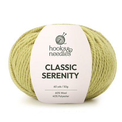 A skein of light green Classic Serenity Yarn, a wool-polyester blend (60 yards/50g), ideal for chunky blankets and cozy super bulky projects.