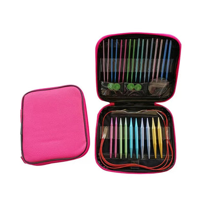 A pink zippered case containing the Aluminum Knitting Needle Set with Case, with multi-colored knitting needles, organizing pouches, and circular cables.