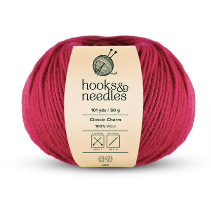 Ball of red yarn from "Classic Charm Yarn," 101 yards/50g, made with 100% wool and suitable for US 7-9 needles.