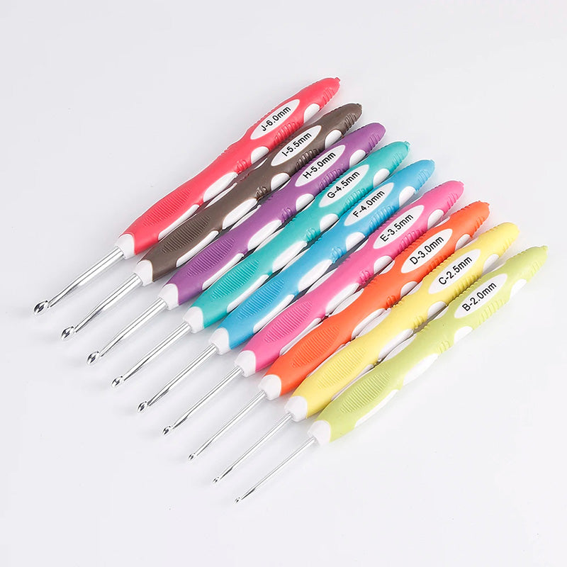 A Crochet Hook Set 9 Pcs with Soft Grip Handles, labeled according to sizes ranging from 2.0mm to 6.0mm, arranged in a diagonal pattern on a white background.