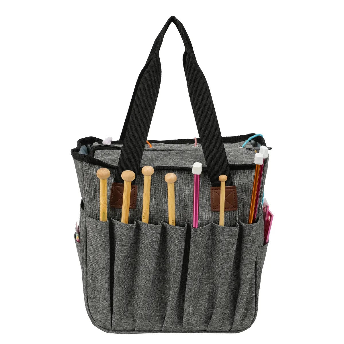 The Yarn Organizer Tote, a gray fabric bag with black handles, serves as a versatile craft organizer. It includes multiple exterior pockets that are ideal for holding knitting needles, making it perfect for all your knitting or crocheting projects.