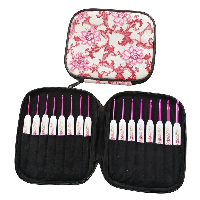 A pink and white floral case open to display the Crochet Hook Set 16 Pcs with Case with white handles and pink tips, showcasing an artistic design crafted from high-quality aluminum alloy.