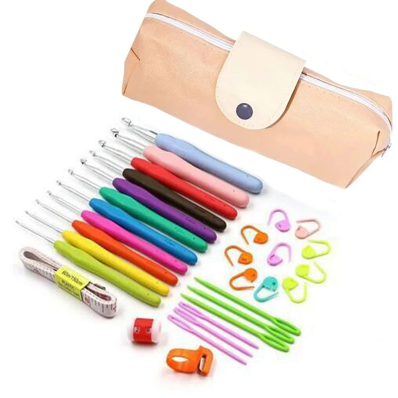 A beige pouch with a white snap button sits next to the Crochet Hook Set 31 Pcs with Bag - Beginner Friendly, including colorful hooks, stitch markers, measuring tape, plastic yarn needles, and small scissors—everything you need for your crafting needs.
