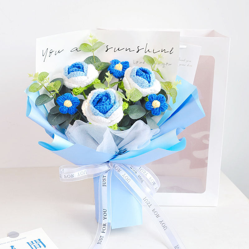 Introducing the Crochet Rose Bouquet - Timeless Blooms (Bundle51), featuring elegant blue and white flowers, complemented by green leaves and a heartfelt card with the message "You are sunshine," all beautifully wrapped in matching blue and white paper.