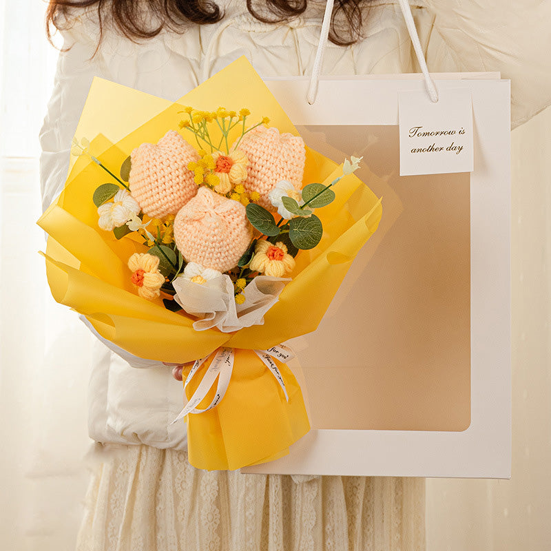 The Crochet Tulip Bouquet: Springtime in Every Stitch offers a beautiful collection of yellow and peach crochet tulips, elegantly presented in yellow wrap that perfectly complements a white gift bag. Accompanying the bouquet is a note that reads, "Tomorrow is another day," making it a timeless gift for any occasion.