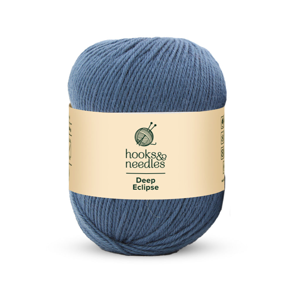 Hooks & Needles offers a 100g skein of Deep Eclipse yarn, crafted from 100% wool and classified as medium weight.