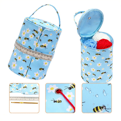 Compact Knitting Bag: Yarn Storage Organizer with bee and flower pattern, featuring a handle. Shown open with yarn inside. Insets display a zipper, crochet hooks, a ruler, a drawstring with a button, and water resistance.
