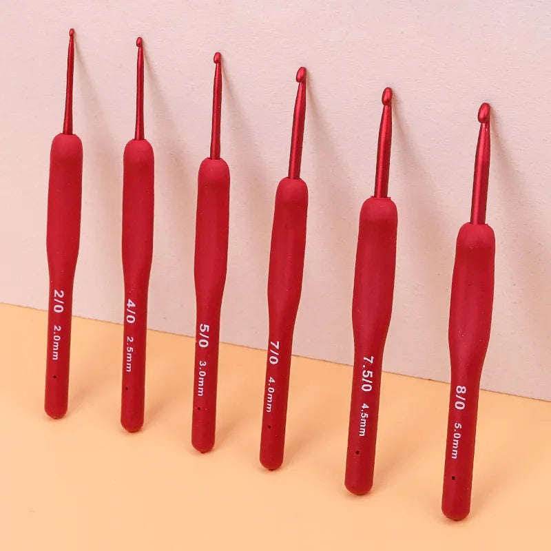 A set of Ergonomic Crochet Hook Set 9 Pcs with Soft Grip Handles, labeled with sizes from 2.0 mm to 5.0 mm, arranged in ascending order on a two-tone background. Perfect for both beginners and experts alike.