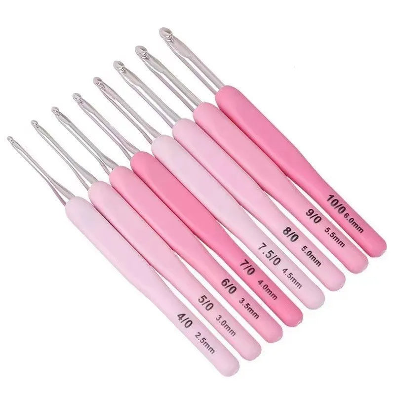 A premium Ergonomic Crochet Hook Set 9 Pcs with Case of nine pink-handled, ergonomic crochet hooks in various sizes, labeled with numbers and corresponding millimeter measurements, arranged in a fan shape for pain-free crocheting.