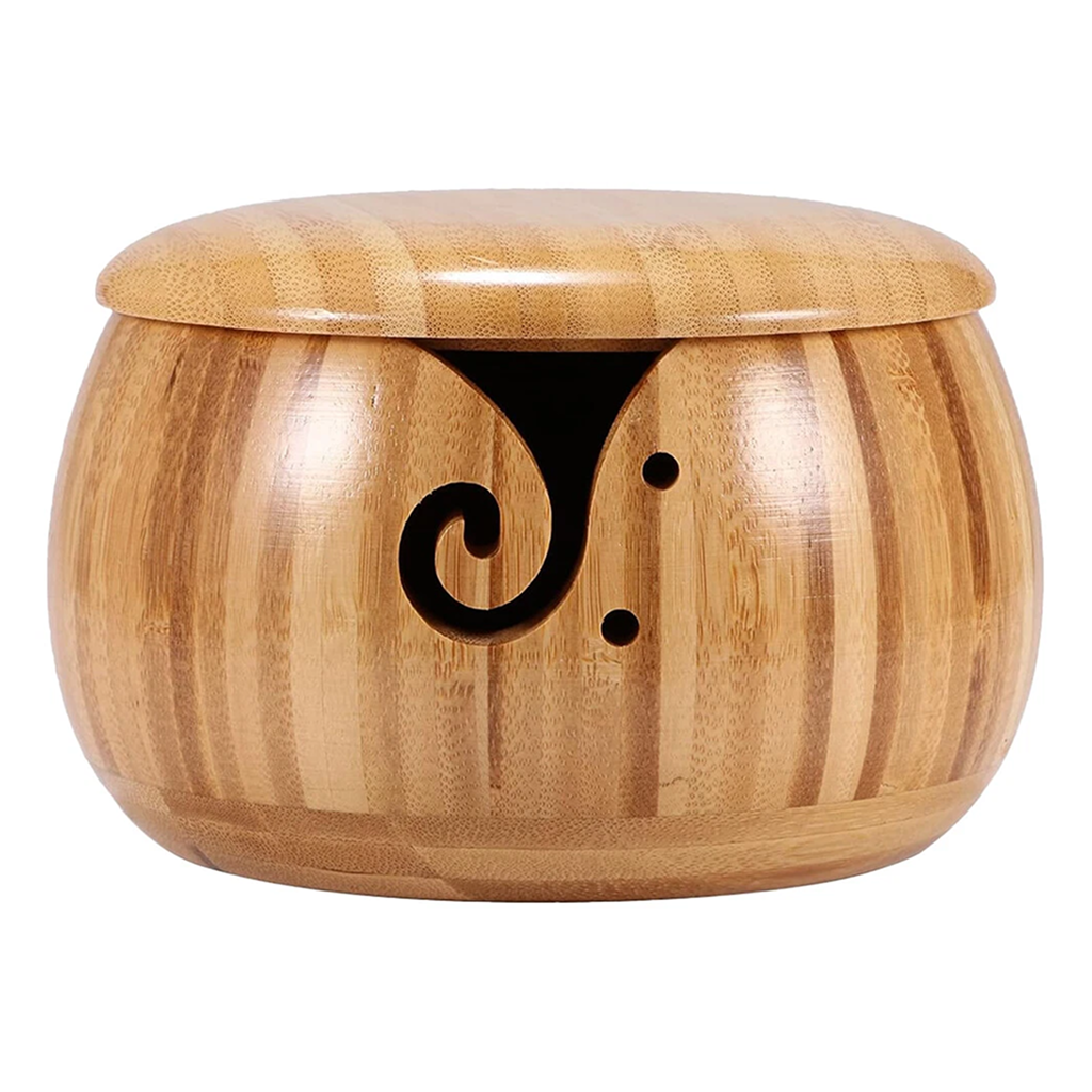 The Wooden Yarn Bowl With Lid features a decorative black swirl on the front, a high gloss finish, and comes with a lid to keep your yarn tidy.