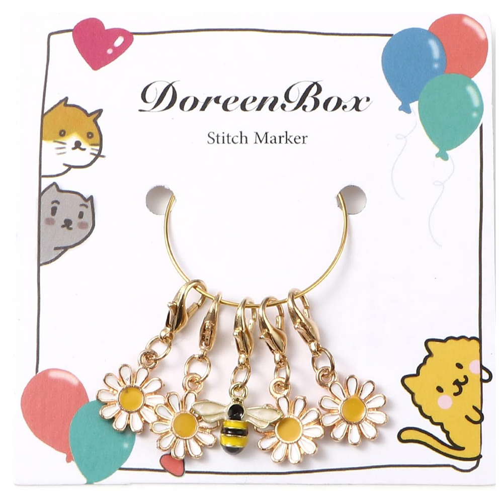The Enamel Flower & Bee Stitch Marker Set 5Pcs includes four daisy charms and one bee charm for yarn crafts, displayed on a card with balloon and cat illustrations labeled "DoreenBox Stitch Marker.