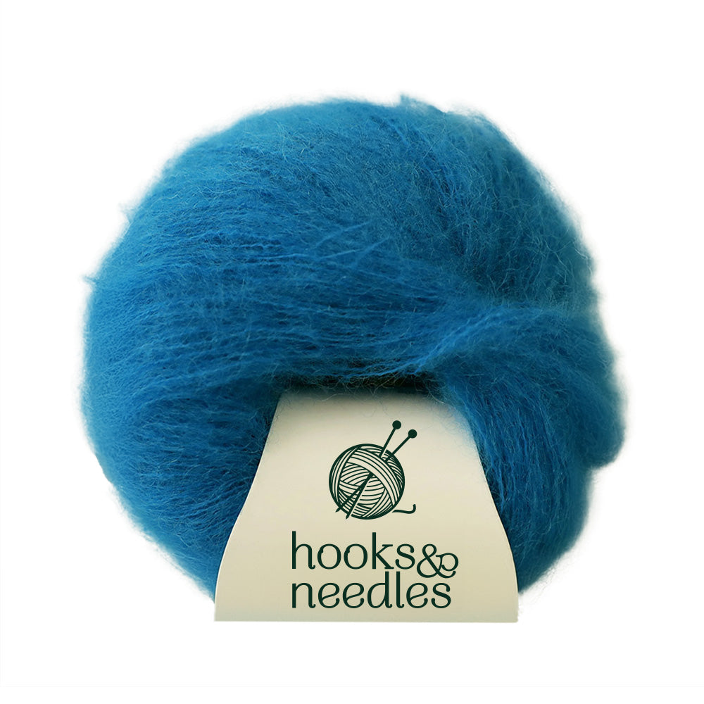 Fusion Finesse Yarn 20g labeled "hooks&needles" featuring soft merino wool in a blue hue.