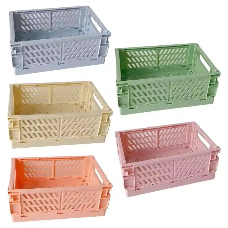 Displayed are five Collapsible Storage Crates (10" x 7")—available in vibrant grey, green, yellow, orange, and pink colors. These crates are ideal for organizing your crocheting accessories and knitting supplies with a splash of color.