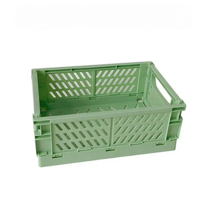 A 10" x 7" collapsible storage crate, designed in green with a ventilated structure and open handles on the shorter sides, ideal for organizing knitting and crocheting supplies.