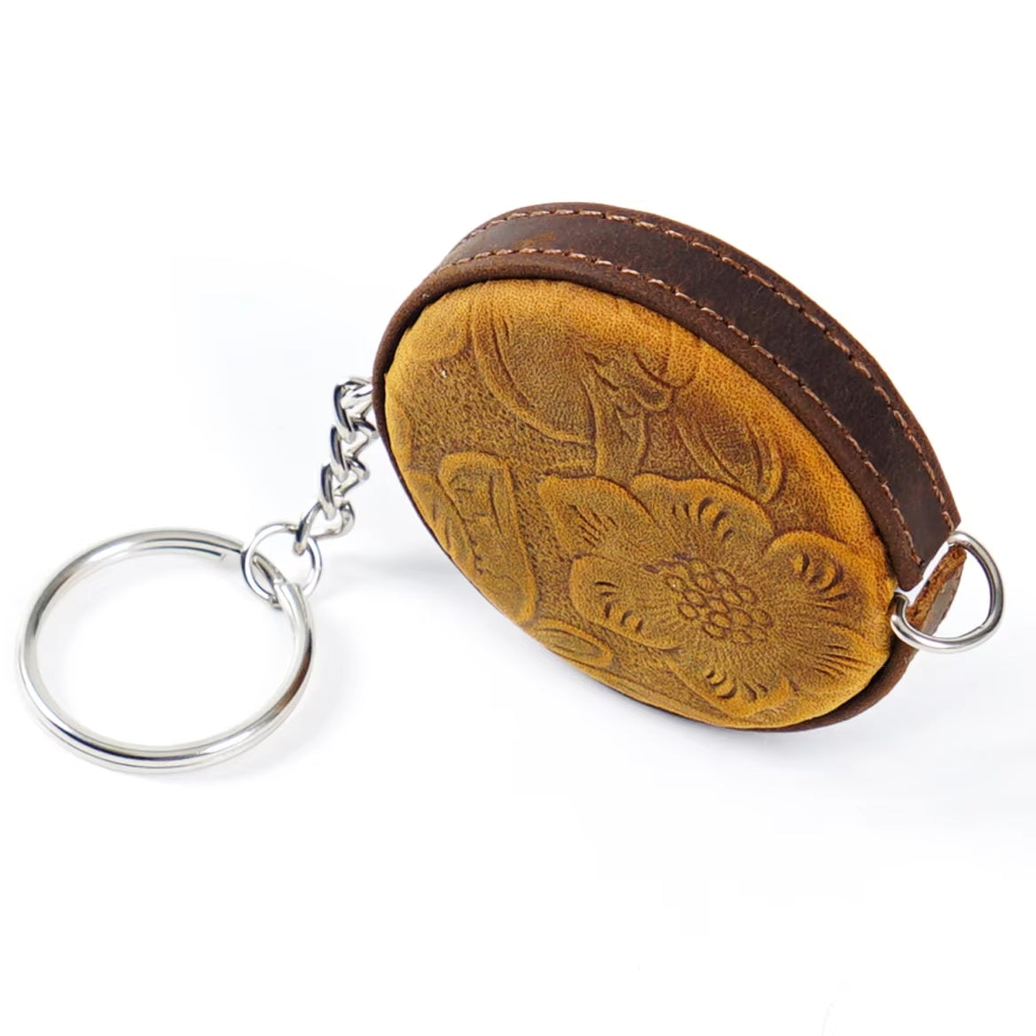 Handmade Leather Mini Tape Measure - 150cm, featuring an embossed floral design and a metallic keyring attached, perfect for adding a touch of elegance to your essentials.