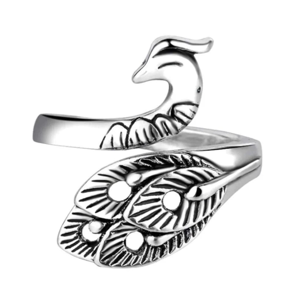 The Yarn Tension Control Ring, an adjustable silver accessory, features an intricate peacock design complete with a detailed head and feather pattern, ideal for the creative spirit seeking elegant adornment.