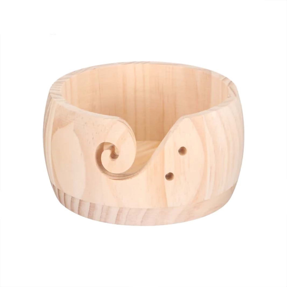 The Handmade Wooden Yarn Bowl showcases a swirl cutout design with two small holes on the side, ideal for keeping your knitting essentials organized.