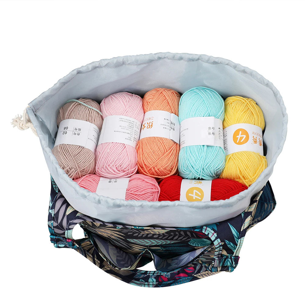 An open Yarn Tote Bag: Knit on The Go displaying eight colorful skeins of yarn in various shades including beige, pink, orange, teal, yellow, red, and green—truly a knitter's essential for any knitting accessory collection.