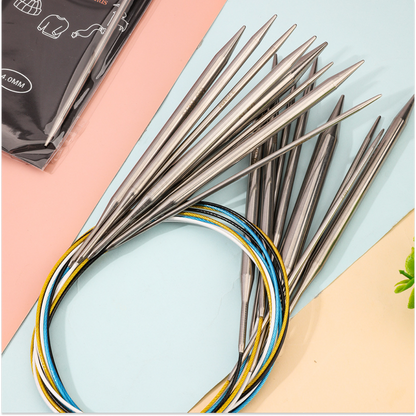 The Stainless Steel Knitting Needle Set, featuring interchangeable stainless steel tips and vibrant cables, is arranged on a pastel background—ideal for diverse knitting projects.