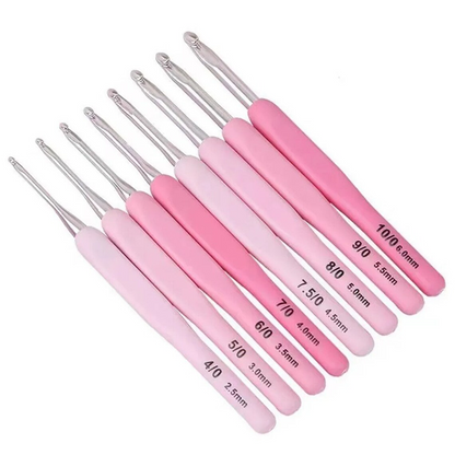 The Ergonomic Crochet Hook Set 9 Pcs with Case includes nine lightweight, durable hooks with pink handles and comfortable grip, labeled sizes 2.5 mm to 6.0 mm, all neatly arranged in a row.
