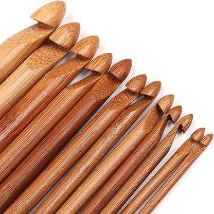 The Bamboo Crochet Hooks 12 Pcs set features various sizes arranged side by side on a white background, highlighting sustainable craftsmanship with eco-friendly bamboo.