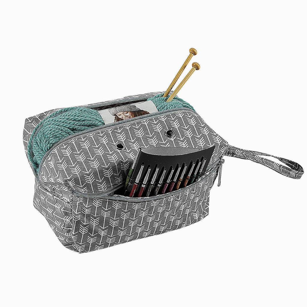 The Portable Knitting Organizer has a grey patterned bag that stores a teal yarn skein, two knitting needles, and colored pencils in the front pocket—ideal for taking your knitting projects anywhere.