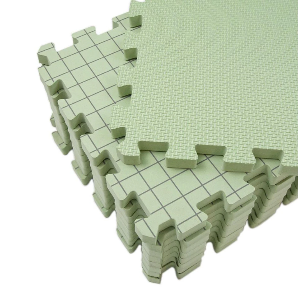 A stack of Knitting Crocheting Blocking Mats in light green, featuring interlocking foam pieces with a textured side and grid-line side for precise alignment.