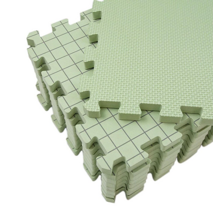 A stack of Knitting Crocheting Blocking Mats in light green, featuring interlocking foam pieces with a textured side and grid-line side for precise alignment.