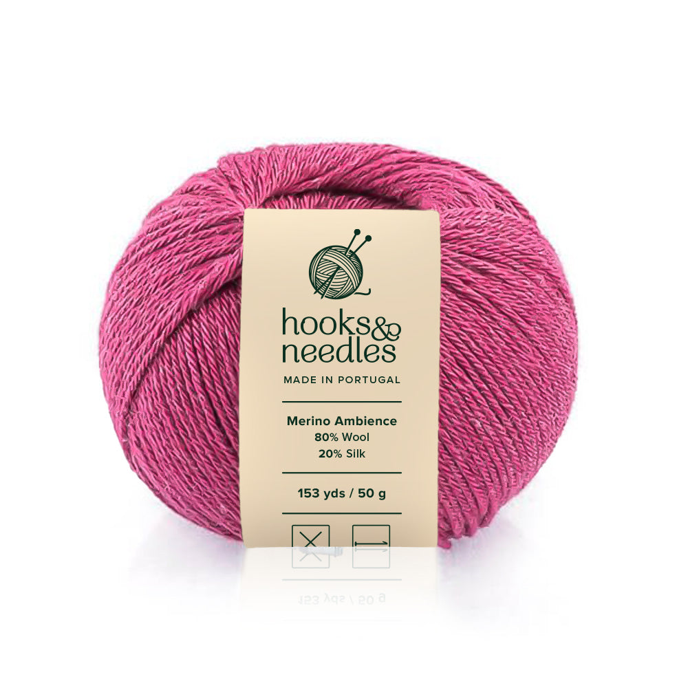 A skein of pink Merino Ambience yarn with a label indicating it