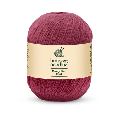 This ball of super fine-weight Mongolian Mist Yarn 50g in dark pink is crafted with anti-pilling fiber, ensuring long-lasting quality.