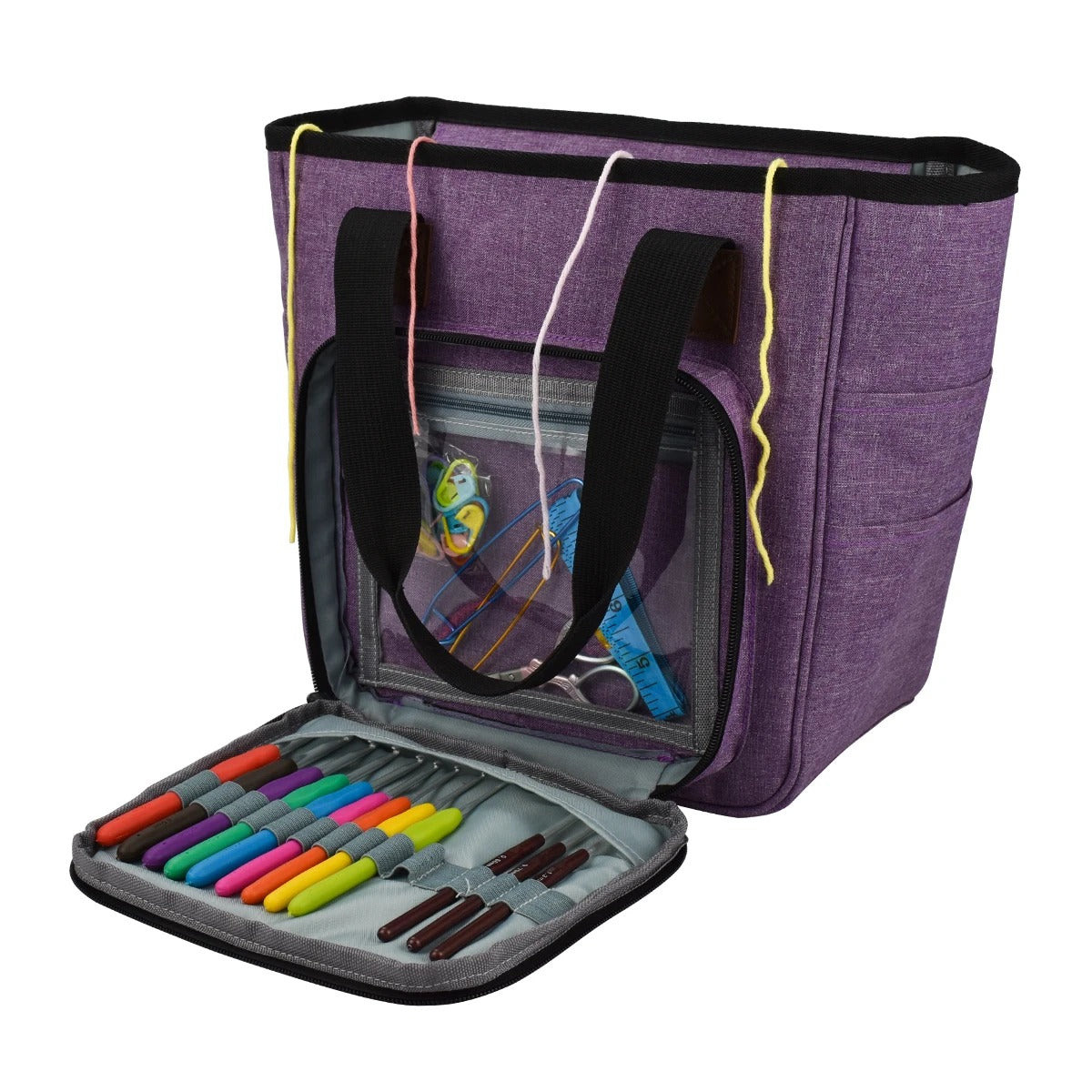 The Yarn Organizer Tote is a purple craft bag with black handles, equipped with a transparent front pocket that reveals sewing supplies inside. The open front flap displays colorful markers neatly arranged in slots, making it ideal for knitting and crocheting enthusiasts.