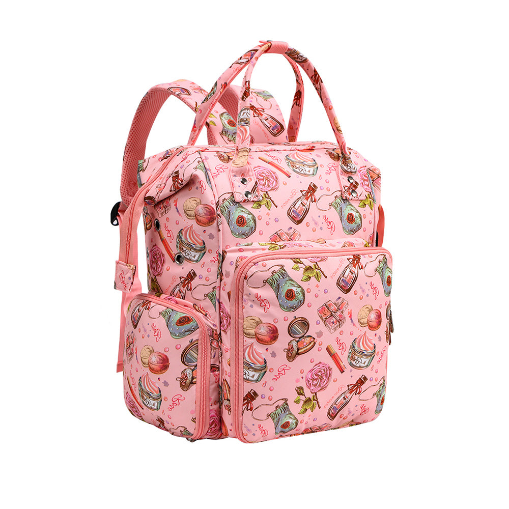 Pink backpack with multiple pockets and a whimsical, colorful pattern featuring various objects like plants, books, and bottles. Perfect as an Oxford Serenity Luxe Bag - Yarn Organizer for all your knitting and crocheting essentials.