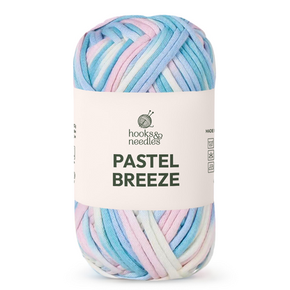A skein of "Pastel Breeze Variegated Yarn" features soft pink, blue, white, and lavender strands—ideal for creating cozy baby blankets.
